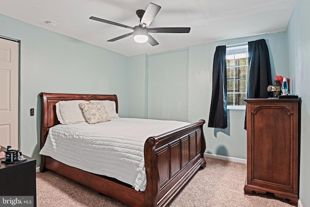 bedroom featuring baseboards, ceiling fan, and light carpet