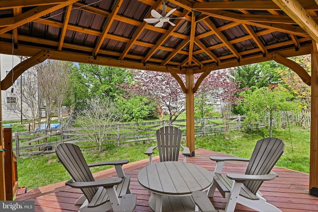 wooden terrace with a gazebo, a fenced backyard, and a yard