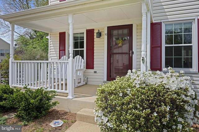 view of exterior entry with a porch