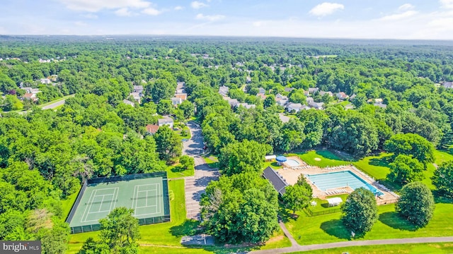 birds eye view of property with a forest view