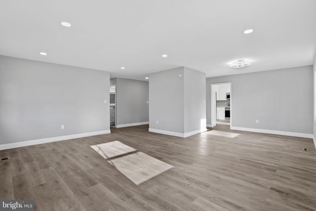 interior space with visible vents, baseboards, recessed lighting, and wood finished floors