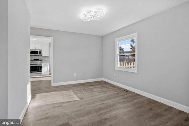 interior space featuring wood finished floors and baseboards