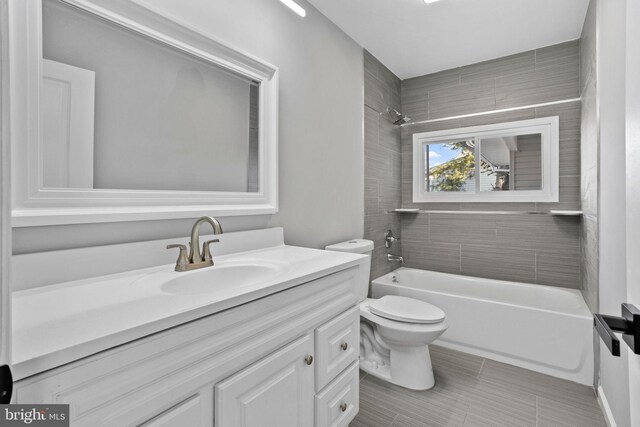 full bathroom with bathing tub / shower combination, vanity, and toilet