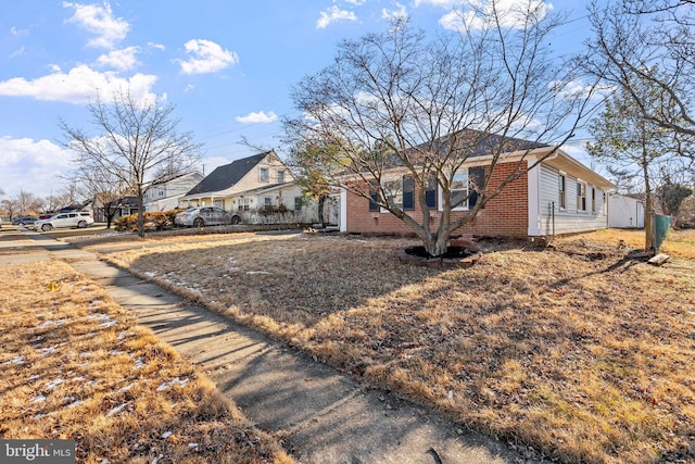 view of home's exterior featuring a residential view and brick siding