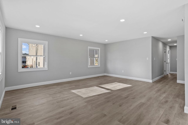 spare room featuring visible vents, baseboards, recessed lighting, and light wood finished floors
