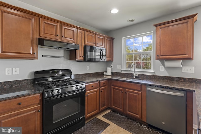 kitchen featuring a sink, recessed lighting, brown cabinetry, under cabinet range hood, and black appliances
