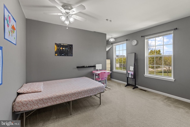bedroom featuring visible vents, carpet flooring, baseboards, and a ceiling fan