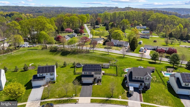 drone / aerial view featuring a forest view and a residential view