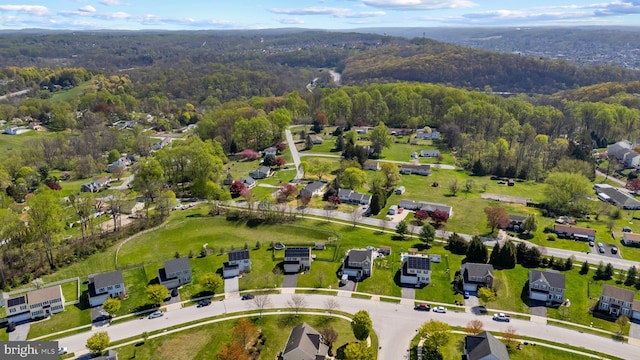 birds eye view of property with a residential view and a wooded view