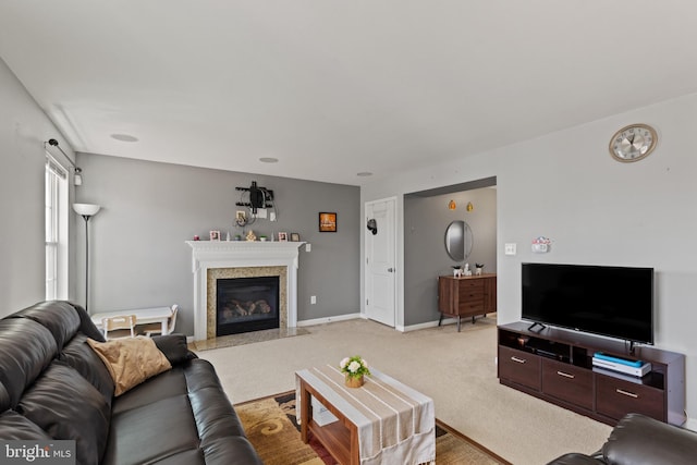 living area with a premium fireplace, baseboards, and light colored carpet