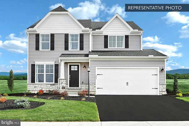 93 Long Bend Dr Lot 155, Carlisle, PA 17015 - view of front of home with an attached garage, stone siding, a front lawn, driveway, and roof with shingles