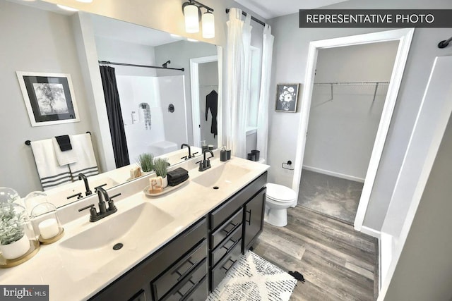 93 Long Bend Dr Lot 155, Carlisle, PA 17015 - full bath with toilet, wood finished floors, a shower with curtain, and a sink