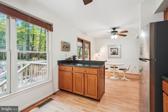 kitchen featuring freestanding refrigerator, a wealth of natural light, visible vents, and ceiling fan