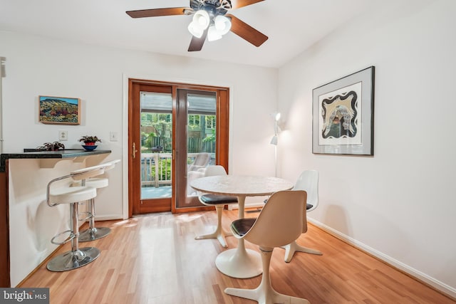 dining space featuring ceiling fan, baseboards, and wood finished floors