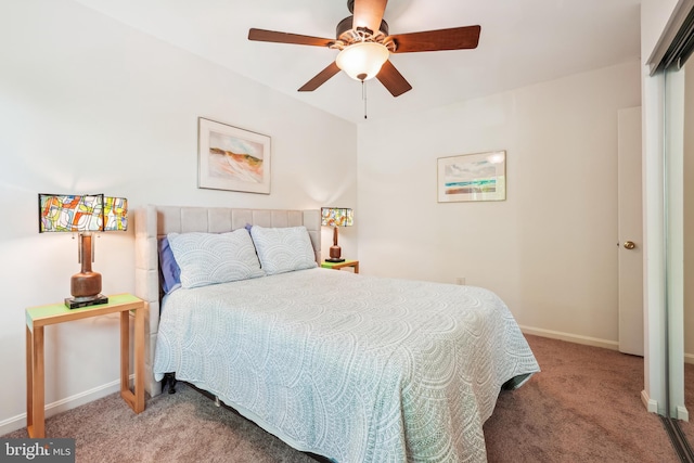 carpeted bedroom featuring baseboards and ceiling fan