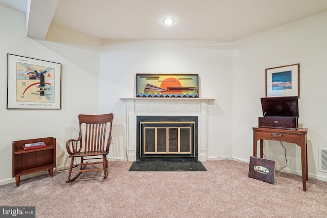 living area featuring carpet floors, a fireplace with flush hearth, baseboards, and recessed lighting