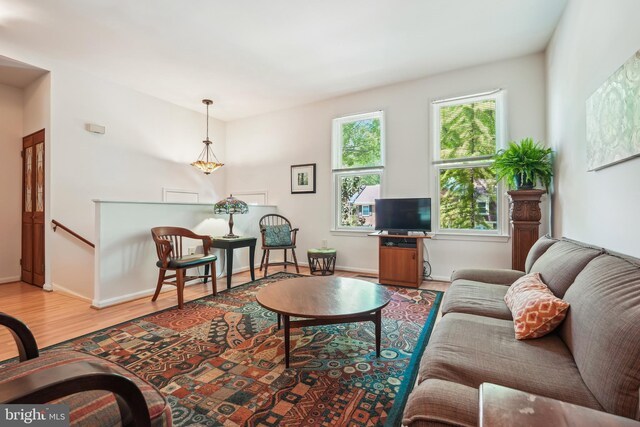 living room featuring light wood-type flooring and baseboards