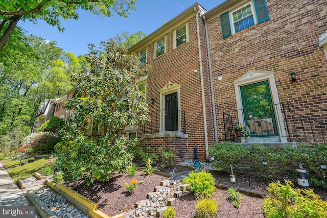 view of side of property featuring brick siding