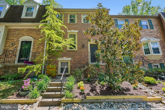 view of property featuring brick siding