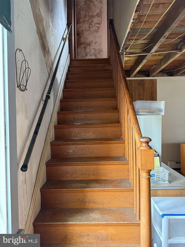 stairs with a baseboard radiator
