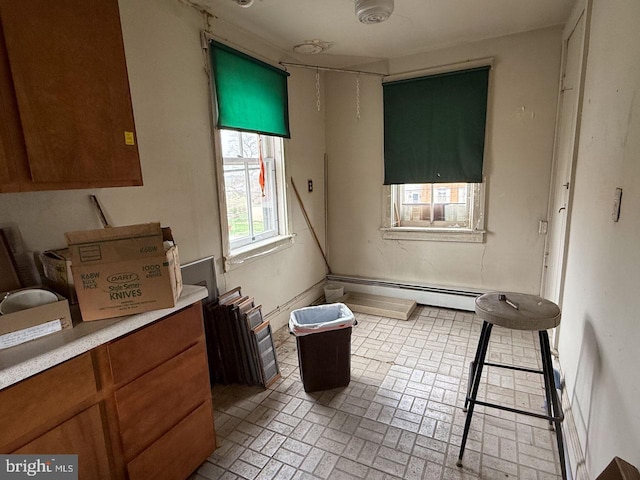 dining area featuring a baseboard radiator and brick patterned floor