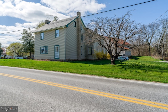 exterior space featuring a front yard and a chimney