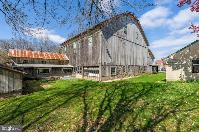 exterior space with an outbuilding, a barn, and a lawn