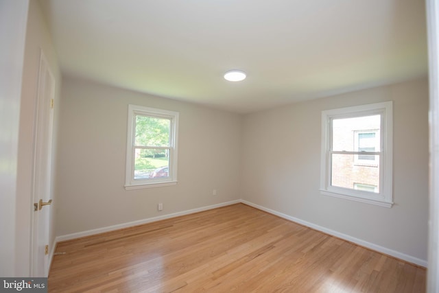 empty room featuring light wood-style flooring and baseboards