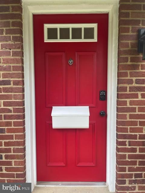 property entrance with brick siding