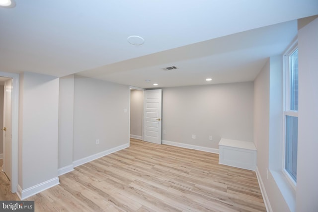finished basement featuring recessed lighting, light wood finished floors, visible vents, and baseboards