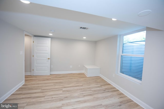 below grade area with light wood-style floors, recessed lighting, visible vents, and baseboards