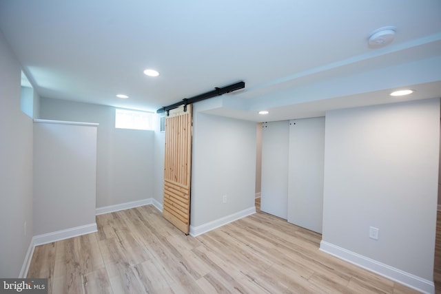below grade area featuring recessed lighting, baseboards, and wood finished floors