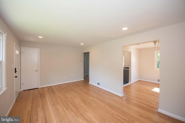 spare room featuring visible vents, baseboards, light wood-type flooring, and recessed lighting