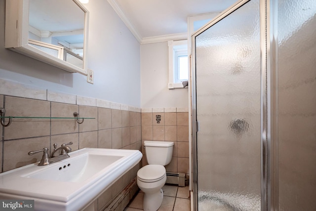 bathroom with a baseboard radiator, toilet, a stall shower, a sink, and tile walls