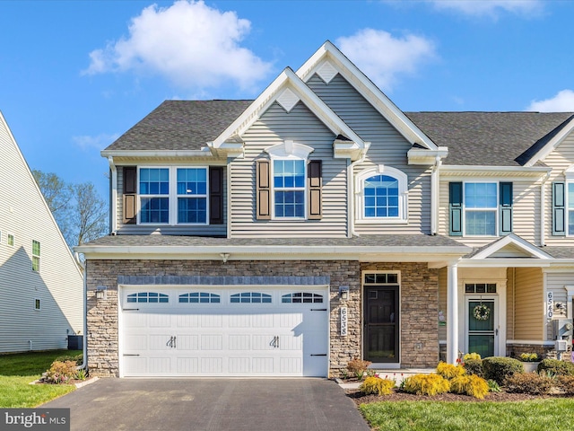 6538 Autumn Olive Dr, Frederick, MD 21703 - craftsman inspired home featuring stone siding, a garage, driveway, and roof with shingles