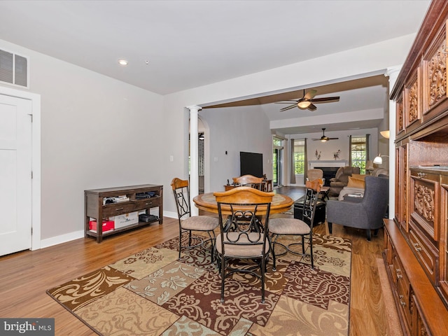 6538 Autumn Olive Dr, Frederick, MD 21703 - interior space featuring a fireplace, a ceiling fan, visible vents, wood finished floors, and baseboards