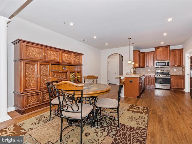 6538 Autumn Olive Dr, Frederick, MD 21703 - dining space featuring arched walkways, ornate columns, visible vents, recessed lighting, and dark wood-style floors