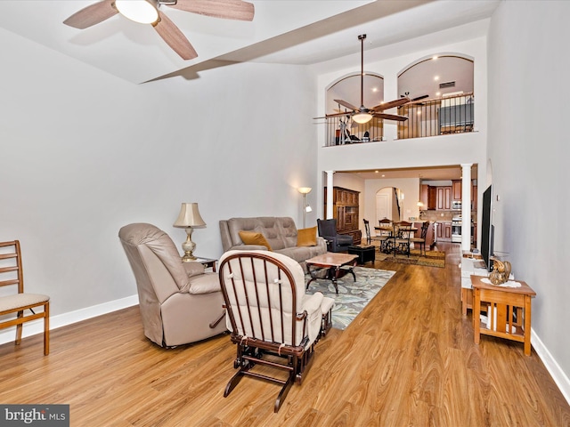 6538 Autumn Olive Dr, Frederick, MD 21703 - living room featuring wood finished floors, decorative columns, baseboards, and a ceiling fan