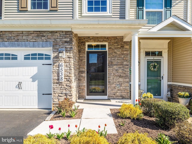 6538 Autumn Olive Dr, Frederick, MD 21703 - view of exterior entry with stone siding and an attached garage