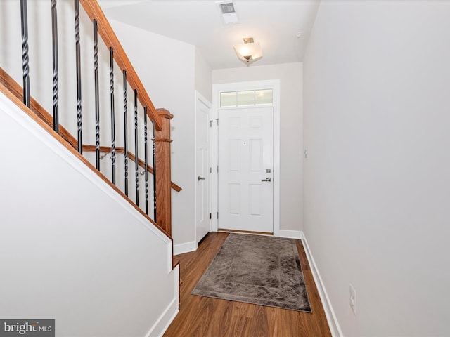 6538 Autumn Olive Dr, Frederick, MD 21703 - foyer entrance with wood finished floors, baseboards, visible vents, and stairway
