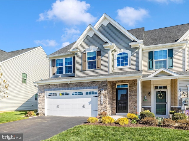 6538 Autumn Olive Dr, Frederick, MD 21703 - view of front of home featuring an attached garage, aphalt driveway, and stone siding