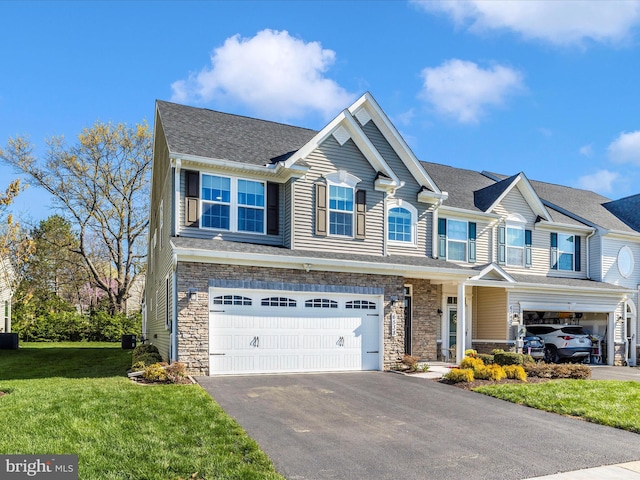 6538 Autumn Olive Dr, Frederick, MD 21703 - view of front of property with an attached garage, aphalt driveway, a front yard, and stone siding