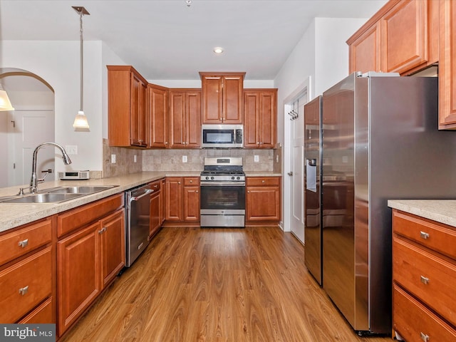 6538 Autumn Olive Dr, Frederick, MD 21703 - kitchen with tasteful backsplash, arched walkways, appliances with stainless steel finishes, dark wood-style flooring, and a sink