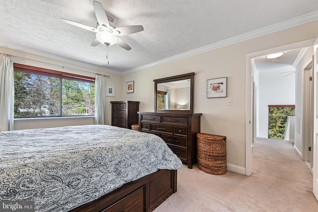 bedroom with baseboards, a textured ceiling, crown molding, ceiling fan, and light colored carpet