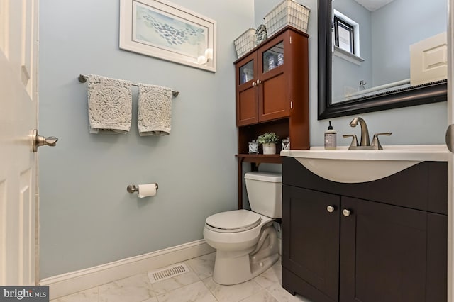 half bathroom with visible vents, baseboards, toilet, vanity, and marble finish floor