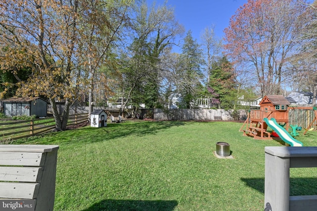 view of yard with a fenced backyard and a playground