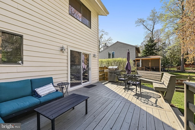 deck with outdoor lounge area and area for grilling