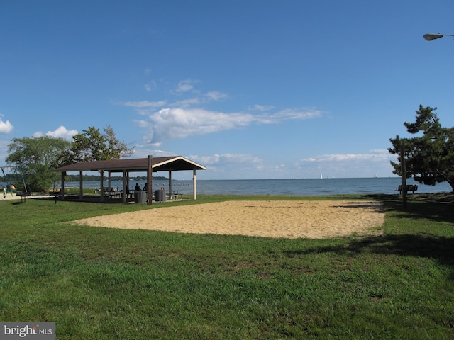 surrounding community with a water view, a gazebo, volleyball court, and a yard