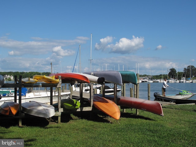 view of dock featuring a water view and a lawn