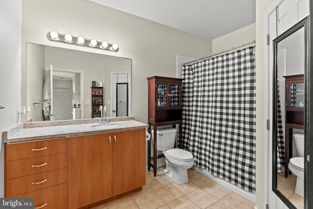 full bath with toilet, a shower with shower curtain, vanity, and tile patterned floors